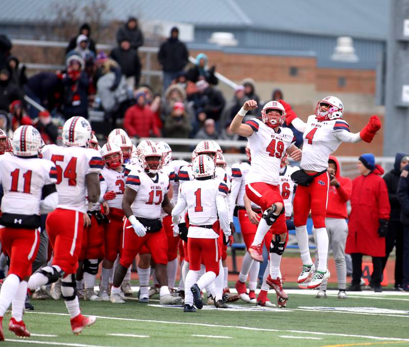 St. Rita players celebrate their win over St. Charles North in their 7A quarterfinal game in St. Charles on Saturday, Nov. 12, 2022.