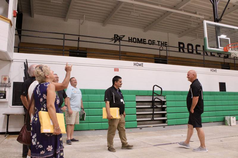 Members of the Rock Falls High School administration provide a tour to board of education members, pointing out the changes in lighting and color scheme for Tabor Gymnasium. These upgrades were part of a larger renovation, the key component being the installation of air conditioning.