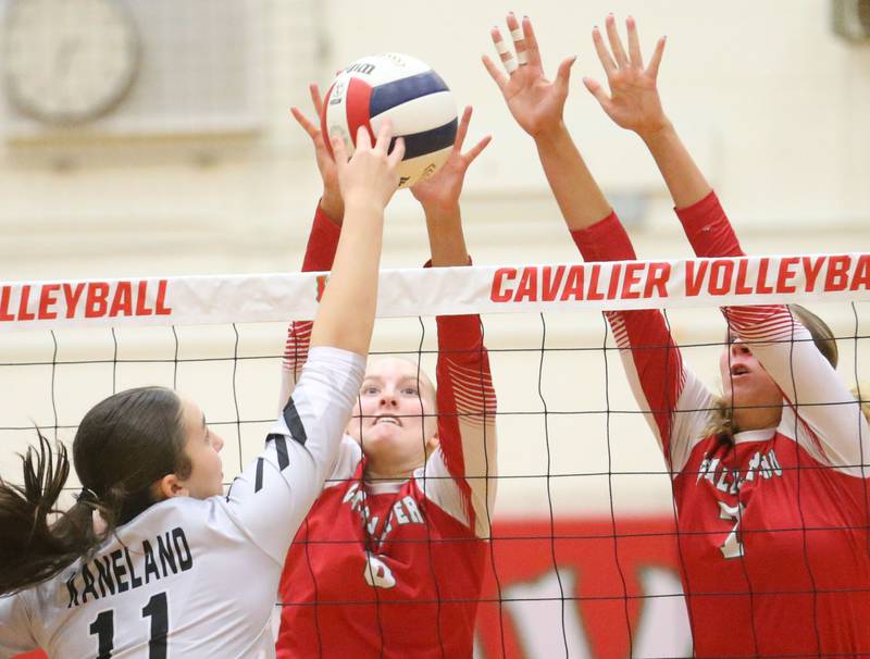 Kaneland's Natalie Remesen has her spike blocked by L-'s Maggie Boudreau and teammate Aubrey Duttlinger on Tuesday, Oct. 7, 2025 in Sellett Gymnasium at L-P High School.