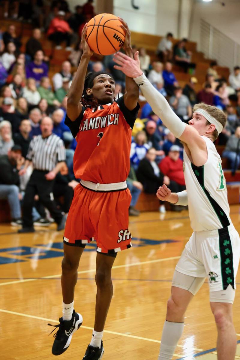 Sandwich's Simeion Harris shoots over Seneca's Paxton Giertz in Wednesday's regional semifinal game at Princeton. The Irish pulled away for a 74-59 win.
