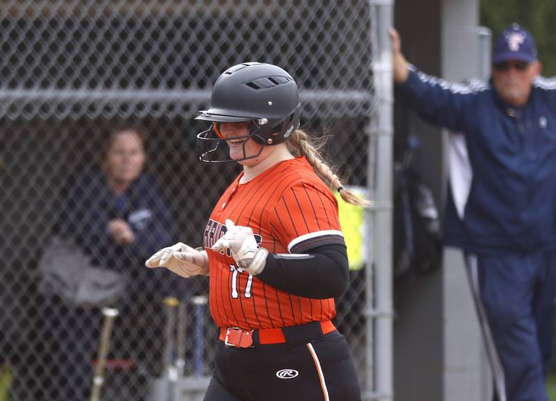 McHenry’s Madison Harvey smiles as her runs the bases after hitting a home run during a Fox Valley Conference Softball game Monday, May 2, 2022, between Cary-Grove and McHenry at Cary-Grove High School.