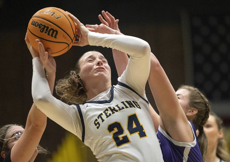 Sterling’s Madison Austin is fouled working under the basket against Rochelle Monday, Feb. 17, 2025, during the girls 3A regional semifinal game in Sterling.
