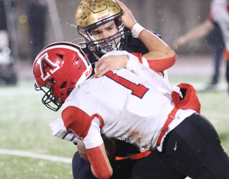 Amboy/LaMoille/Ohio's Jose Lopez is brought down from behind by Polo's Eli Perez during the 8-man I8FA championship game on Friday, Nov. 21, 2025 at April Zorn Memorial Stadium in Monmouth.