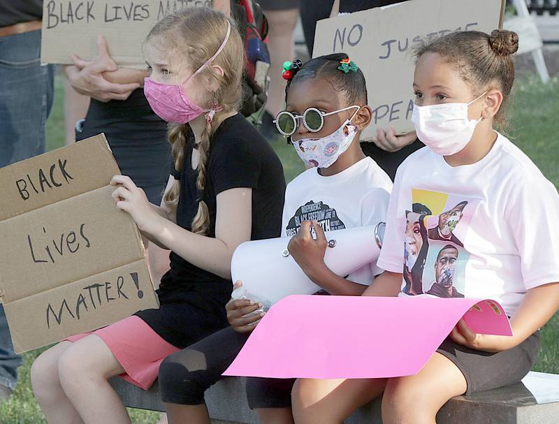 Ariana Lessman 10, of La Salle, Lam'yah Mayfield 8, of Ottawa and Miabella Capitani 6, of Ottawa hold signs that read "Black Lives Matter" while listening to poems and speeches during the Junteenth event at Washington Square in Ottawa on June 19th. Juneteenth commemorates when all enslaved African Americans learned they were free in 1865.