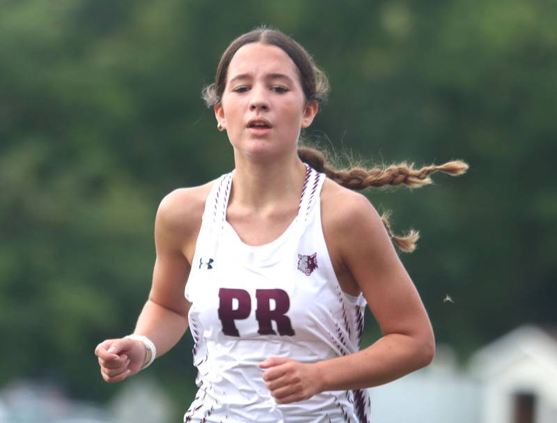 Prairie Ridge’s Emaline Foster wins the girls varsity race of the McHenry County Cross Country Meet at Emricson park in Woodstock on Saturday, August 30, 2025.