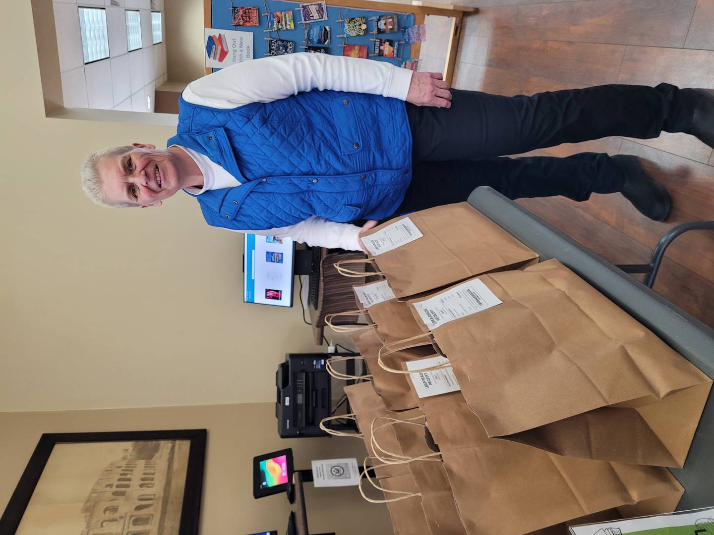 Sterling Public Library Director Jennifer Slaney is shown with bags packed as part of the “Uber Reads" program.