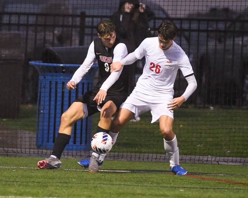 Prairie Ridge's Henry Knoll (9) and Benet Academy's Daniel Sterba (26) battle for the ball during the class 2A super sectional soccer match on Tuesday Nov. 5, 2024, held at Wheaton Academy in West Chicago.