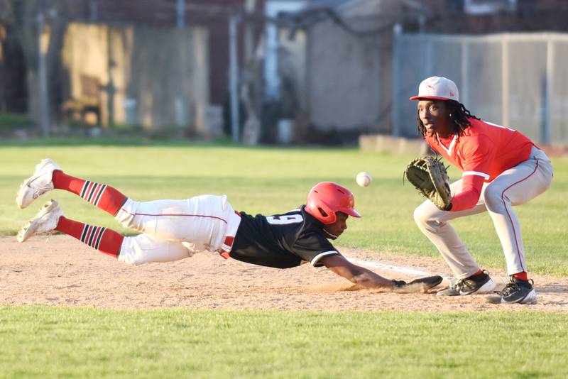 Bradley-Bourbonnais' Byron Sumrall, left, dives back to first base safely as Homewood-Flossmoor's Authur Stamps fields a pickoff throw during a game at Bradley-Bourbonnais Friday, April 11, 2025.