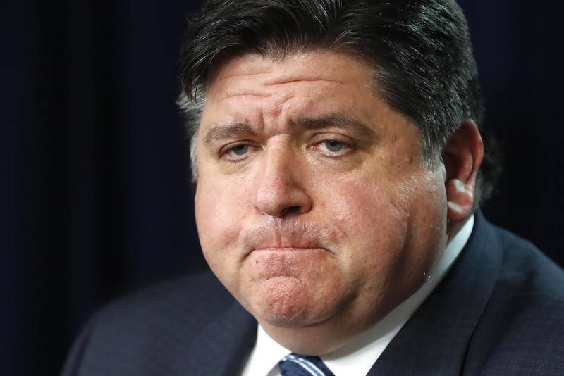 Gov. J.B. Pritzker listens to a question Thursday after announcing that three more people have died in the state from from Covid-19 virus, two Illinois residents and one woman visiting from Florida, during a news conference in Chicago.