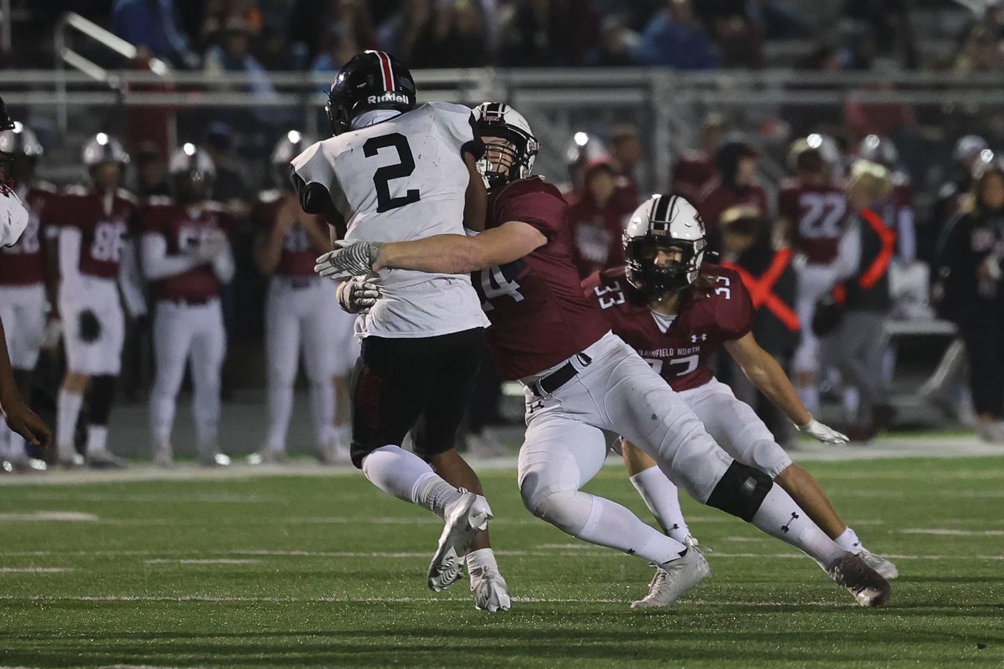 Plainfield North’s Logan Rooney wraps up Rich Township’s Myrion Hogue for no gain in the 1st round of the playoffs on Friday.