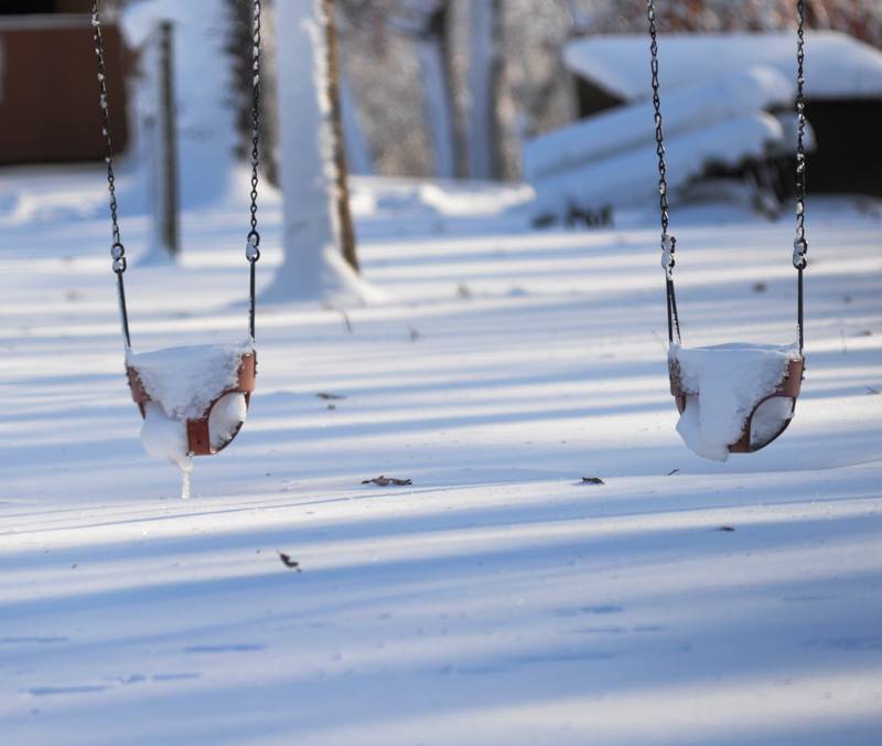 Toddler swings are filled with snow at Lowden State Park on Sunday, Jan. 14, 2024. Frigid weather followed a winter storm on Friday that deposited 10-12 inches across the region.