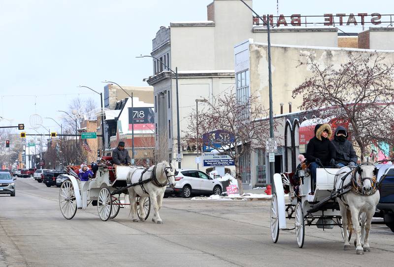 People take a carrage ride during the Miracle on First Street event on Saturday, Dec. 6, 2025 in La Salle.