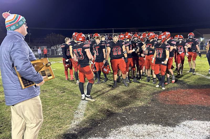 Fulton High School Athletic Director Roy Borgman gets ready to present the traveling Wooden Shoe Trophy to the Steamers football team after they beat Morrison 41-7 on Friday, Oct. 25, 2024.