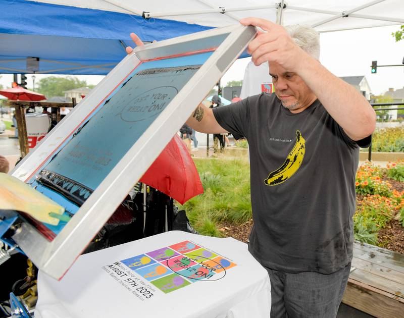 Joe Fruzyna of SBI Tees creates silk screen tee shirts during the Fine and Cultural Arts CommissionÕs Andy WarholÕs birthday celebration in Wheaton on Saturday, August 5, 2023.