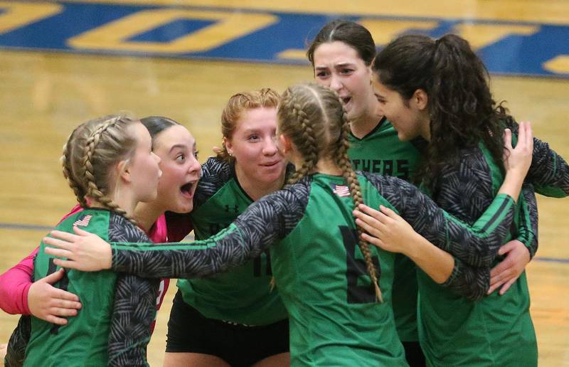 Members of the Leland volleyball team react after winning the first set against Earlville during the Class 1A Regional semifinals on Monday, Oct. 27, 2025 at Somonauk High School.