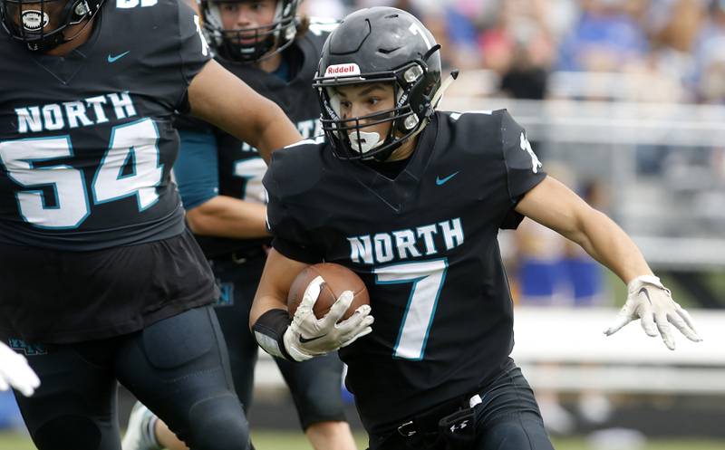 Woodstock North's George Kingos runs with the ball during a Kishwaukee River Conference football game against Johnsburg Saturday, Aug. 26, 2023, at Woodstock North High School.