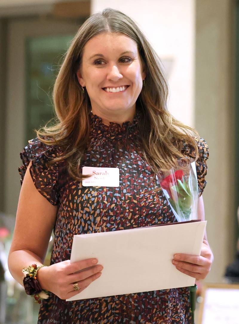 Athena Award finalist Sarah Newby returns to her seat after being recognized Tuesday, Oct. 18, 2022, during the Athena and Women of Accomplishment Award reception at the Barsema Alumni and Visitors Center at Northern Illinois University in DeKalb.