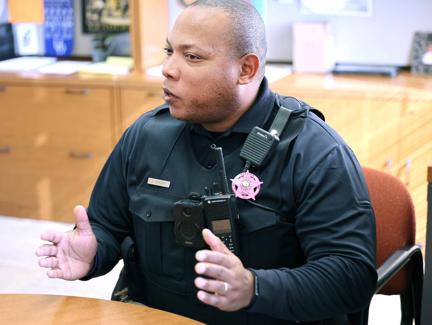 Josef Gordon, DeKalb Police officer and student resource officer at DeKalb High School, talks Thursday, Oct. 20, 2022, at the school, about what he enjoys most about working with students and some of the challenges that it can create.