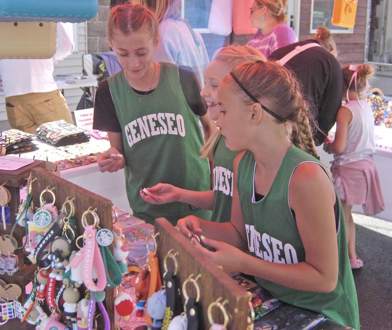 Regann Lopez, Pageyn Dauts and Eden Ebert of Geneseo pick out pins at the Port Byron-hosted Great River Tug Fest across the Mississippi River on Saturday, Aug. 10, 2024.