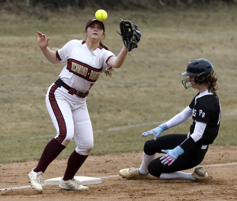 Prairie Ridge's Kylie Carroll slides into third base ahead of the throw to Richmond-Burton’s Kacie Taylor during a nonconference softball game on Tuesday, March 18, 2025, at Richmond-Burton High School.