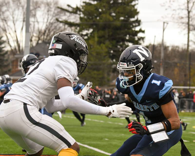 Nazareth Academy's Trenton Walker (1) tries to get around Fenwick's defender Josh Morgan (2) during the 6A semifinals game on Saturday Nov. 22, 2025, held at Nazareth Academy High School in La Grange Park.