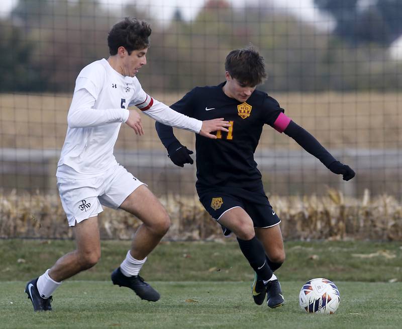 Richmond-Burton's Jack Meyer (right) tries to get position to take a shot on goal as F.W. Parker's F.W. Parker's Heath Albert defends during an IHSA Class 1A Johnsburg Sectional semifinal match on Oct. 28, 2025, at Johnsburg High School.