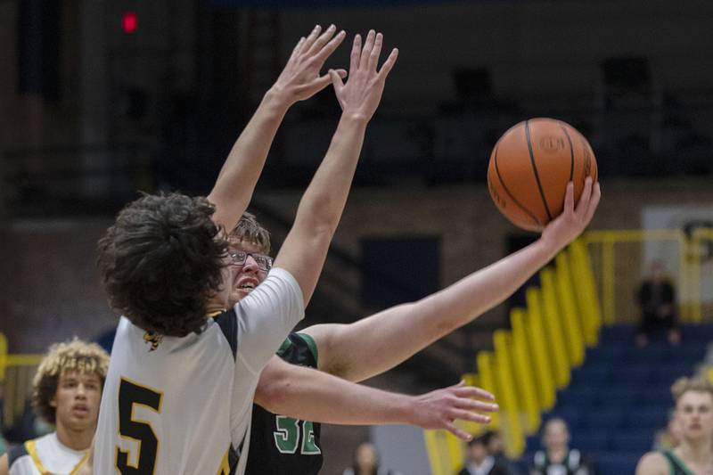 Rock Falls’ Chevy Bates puts in a shot while being fouled by Hinsdale South’s Nate Marcopulos Monday, Jan. 10, 2023 at Sterling High School’s MLK Classic basketball tournament.