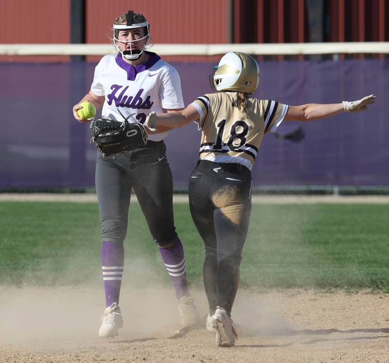Sycamore's Addison McLaughlin calls herself safe at second as Rochelle's Madigan Williams looks on Monday, April 15, 2024, during their game against Rochelle at Rochelle High School.