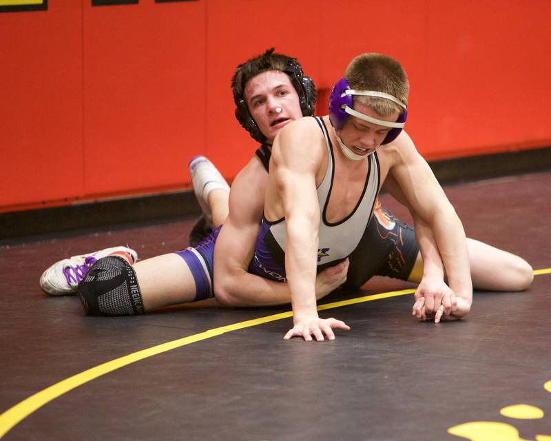 McHenery's Ryan Hanson competes against Hononegah's Evan Musil in the 132 lb weight class at the Clint Arias Invitational on Saturday, Jan.18,2025 in Batavia.