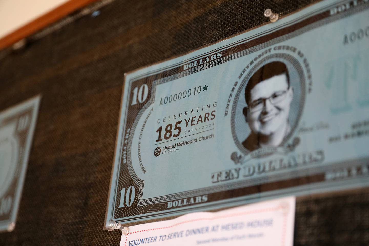 The face of Pastor Rob Hamilton adorns “Hamilton Bucks” to be used during the United Methodist Church of Geneva’s celebration of the185th year of official gatherings of Methodists in Geneva along with 150 years in the current location on Hamilton Street Sept. 27-29, 2024 in Geneva.