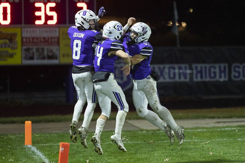 Dixon’s Tyson Dambman (left), Carter Kibble and Exzadrian Diaz celebrate Dambman’s TD against Chicago Ag Science Friday, Nov. 8, 2024 in the second round of the Class 4A football playoffs.