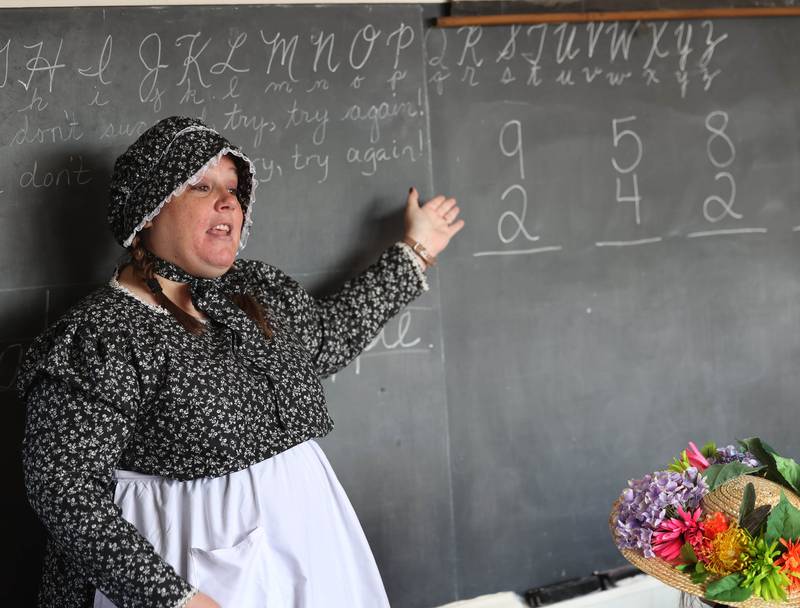 Southeast Elementary School third grade teacher Jami Sauber teaches her students Tuesday, Nov. 4, 2025, during a field trip to North Grove School, a one-room schoolhouse from 1878 in Sycamore.