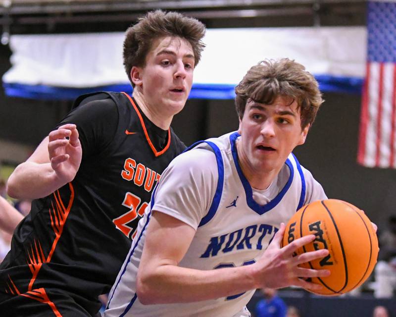 Wheaton North's Ben Gillmar, right,  drives to the basket while being defended by Wheaton Warrenville South's David Showman (23) during the game on Friday Feb. 6, 2026, held at Wheaton North. High School,