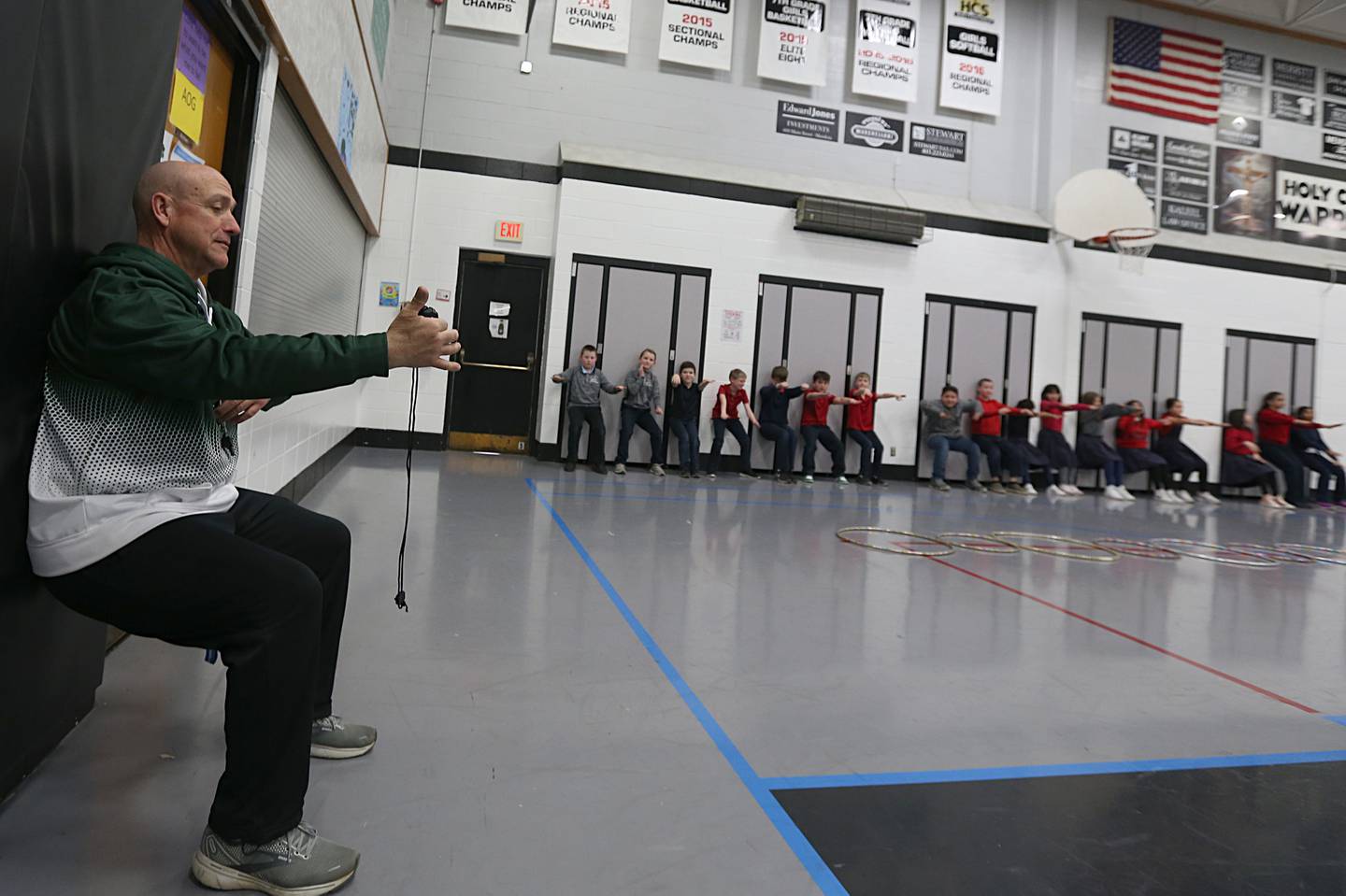 Bill Booker teaches physical education on March 21, 2023 at Holy Cross School in Mendota.