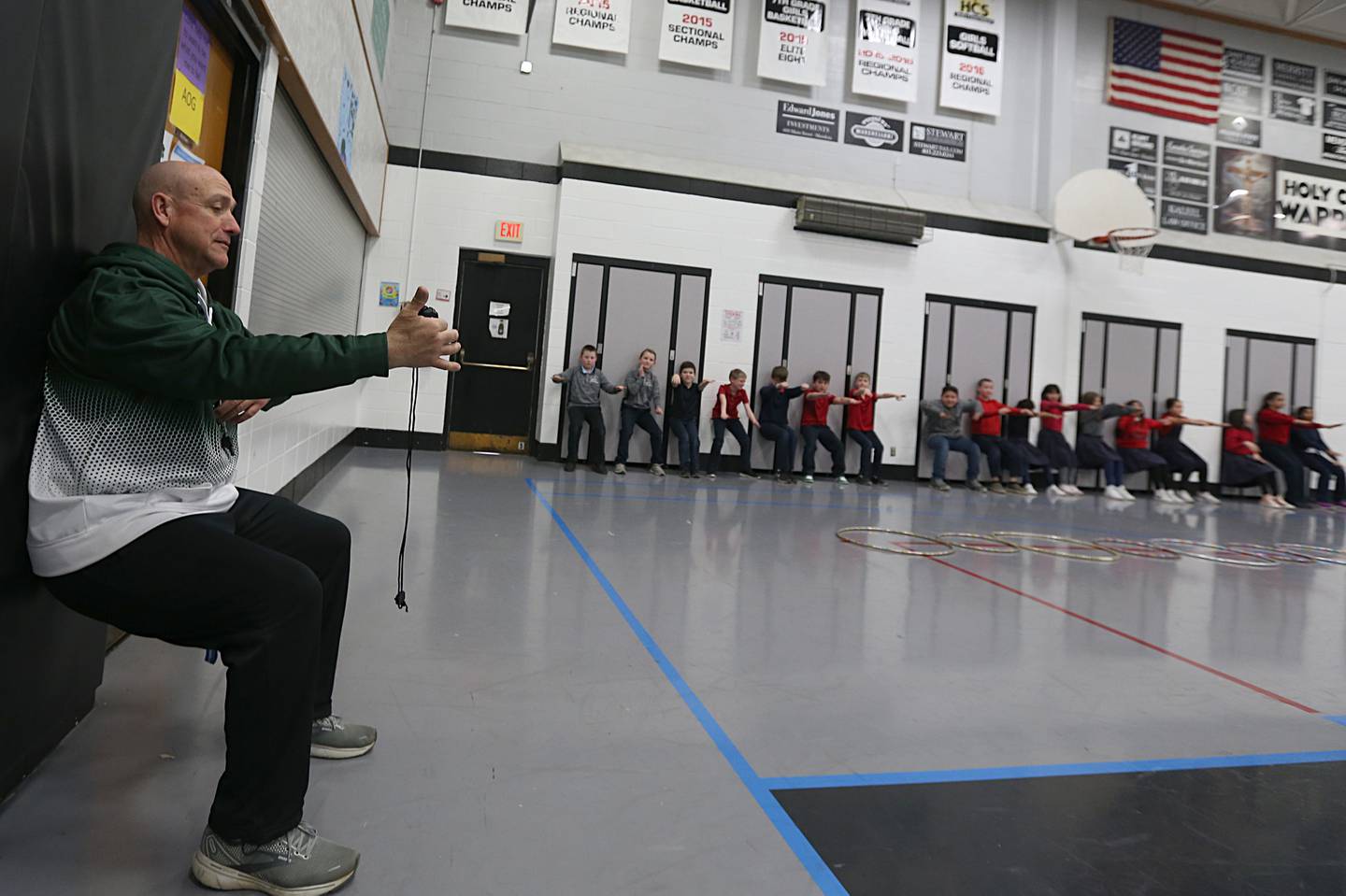 Bill Booker teaches physical education on March 21, 2023 at Holy Cross School in Mendota.