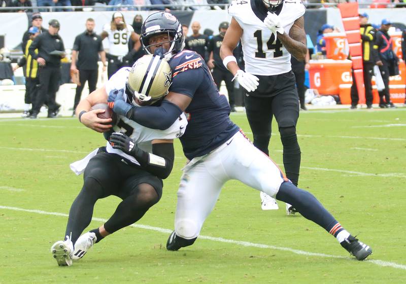 Chicago Bears defensive lineman Dominique Robinson brings down New Orleans quarterback Taysom Hill on Sunday, Oct. 19, 2025 at Soldier Field in Chicago.
