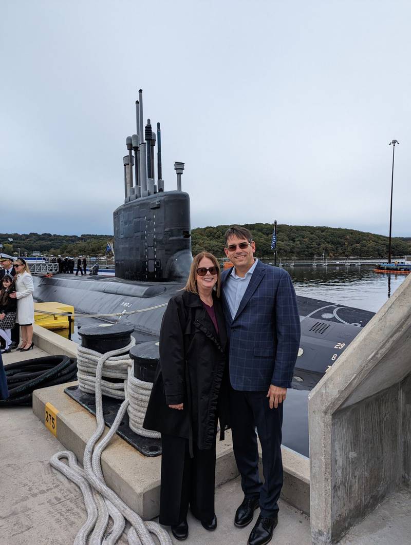 Illinois Sparking Co. owners Mark and Teri Wenzel had their photo taken after the commissioning ceremony of the USS Hyman G Rickover. Their wine Blend 795 was created specifically for the christening of the submarine, which occurred in July 2021. The wine was served Oct. 13 at the unveiling of the Admiral Hyman Rickover exhibit at the Submarine Force Museum.