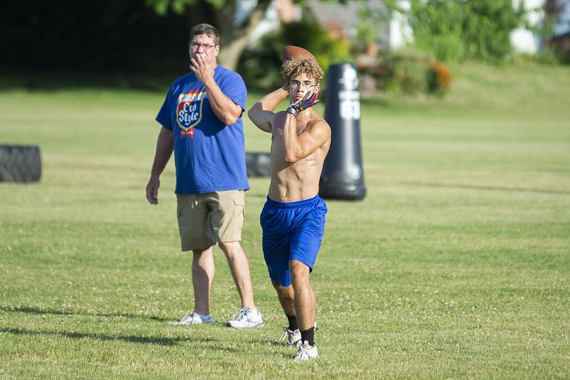 Polo coach Ted Alston watches as Avery Grenoble fires a pass during camp Thursday, July 7, 2022.