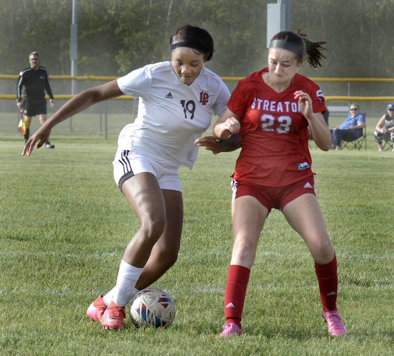 La Salle-Peru's Iyana Jones (19) and Streator’s Aubree Gallick (23) battle for a 50/50 ball Friday, May 16, 2025, at Streator.