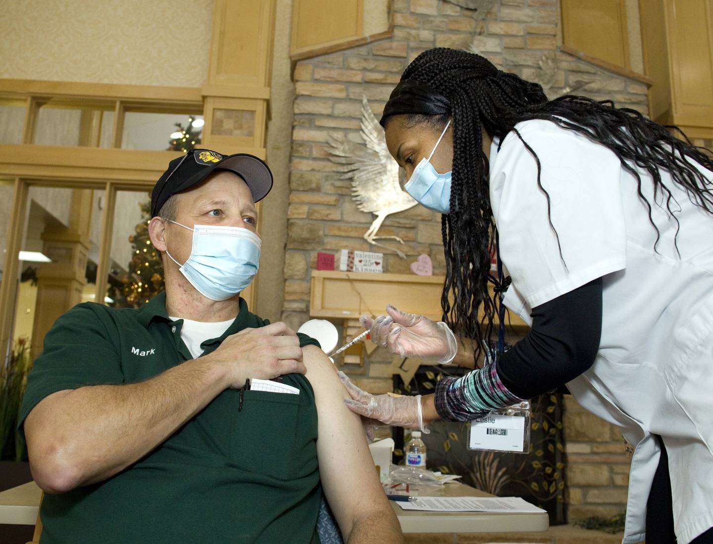 Timbers of Shorewood employee Mark Zvokel receives the COVID-19 vaccine from Walgreens Pharmacists Leslie Jones-Hunter at Timbers of Shorewood on January 7, 2021, in Shorewood, Ill.