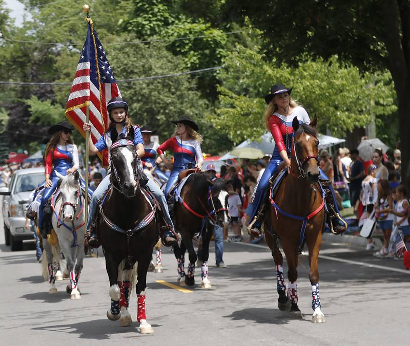 Members of the Midwest Renegades Equestrian Drill Team ride their horses on Sunday, July 6, 2024, during Crystal Lake’s annual Independence Day Parade on Dole Avenue in Crystal Lake.