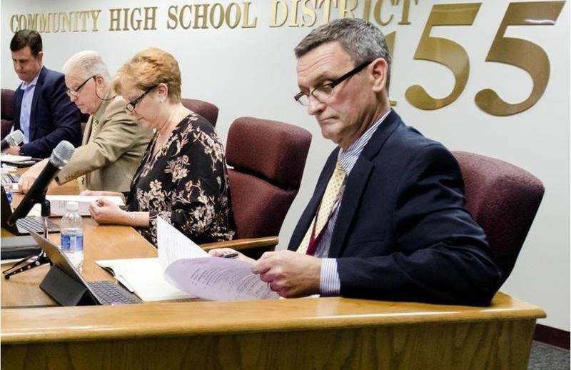 Crystal Lake High School District 155 Superintendent Steve Olson reviews notes during a meeting.