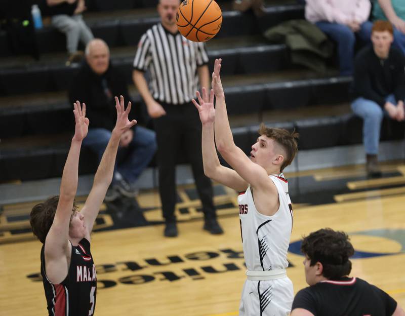 Woodland's Noah Decker shoots a jump shot over Henry-Senachwine's Jacob Miller during the Tri-County Conference Tournament on Monday, Jan. 26, 2026 at Putnam County High School