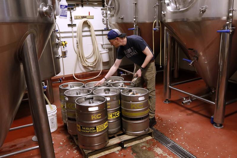 Assistant brewmaster Ryan Anderson caps kegs of Crystal Lake Brewing’s Beach Blonde on Friday, May 3, 2024 at the Crystal Lake Brewing. The brewery is celebrating its 10th anniversary and recently won a bronze award in Brown Porter category at the World Beer Cup in Las Vegas.