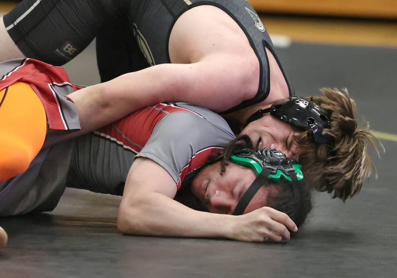 Sycamore’s Douglas Gemberling controls Ottawa’s Malikhai Stayton during their 157 pound match Thursday, Dec. 14, 2023, at Sycamore High School.