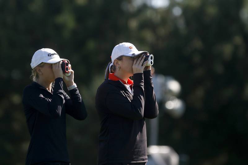Prairie Ridge’s Jenna Albanese and Crystal Lake Co-op’s Delaney Medlyn measure the distracts to the flag on the eight hole during the IHSA Class 2A Huntley Girls Golf Regional on Tuesday, Oct. 1, 2024, at Pinecrest Golf Club in Huntley.