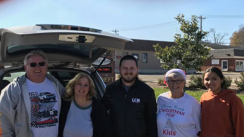 (L-R) Scott Bickett, Wendy Bickett, Dalen Fallenwirth, Deb Stanbary, and Khymber Thompson. Scott and Wendy Bickett, and Dalen Fallenwirth of the  Illinois Valley Toy Run and AMC Sound DJ, delivered a car load of toys and coats for the kids.