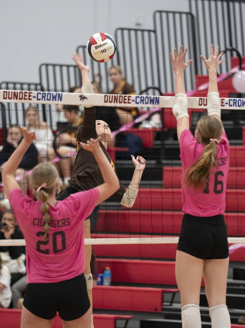 Jacobs' Rachelle Zieba spikes the ball in between Dundee-Crown's Olivia Rodriguez and Victoria Brents during their game on Thursday, October 16, 2025 at Dundee-Crown High School in Carpentersville. Ryan Rayburn for Shaw Local