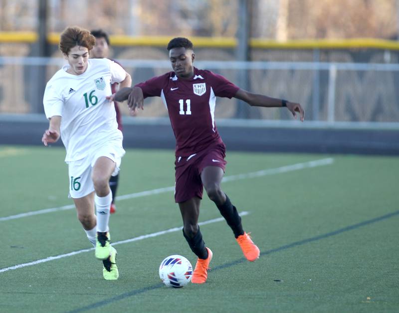 York’s Stefan Rebic (16) and Elgin’s Ola Ajayi go after the ball in the first half of the 3A Boys Soccer Supersectional at Streamwood High School on Tuesday, Nov. 1, 2022.