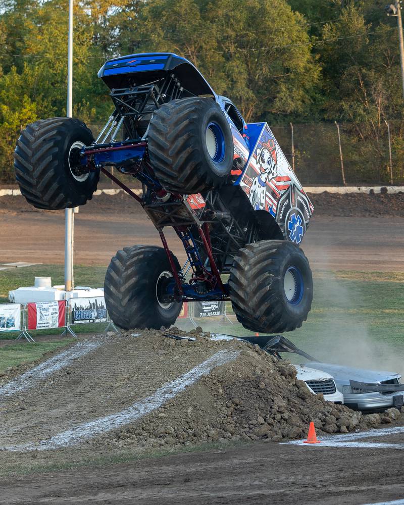 Driver of the Monster Truck 'Rescue Racer' flies over 2 cars and ramp at the Monster Truck Bash on Saturday, Sept. 13, 2025 at the La Salle Speedway in La Salle.